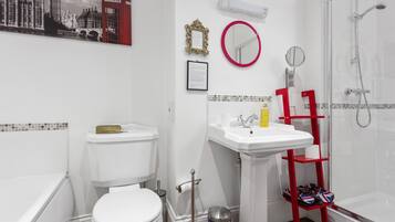A modern bathroom with a toilet, sink, and shower.