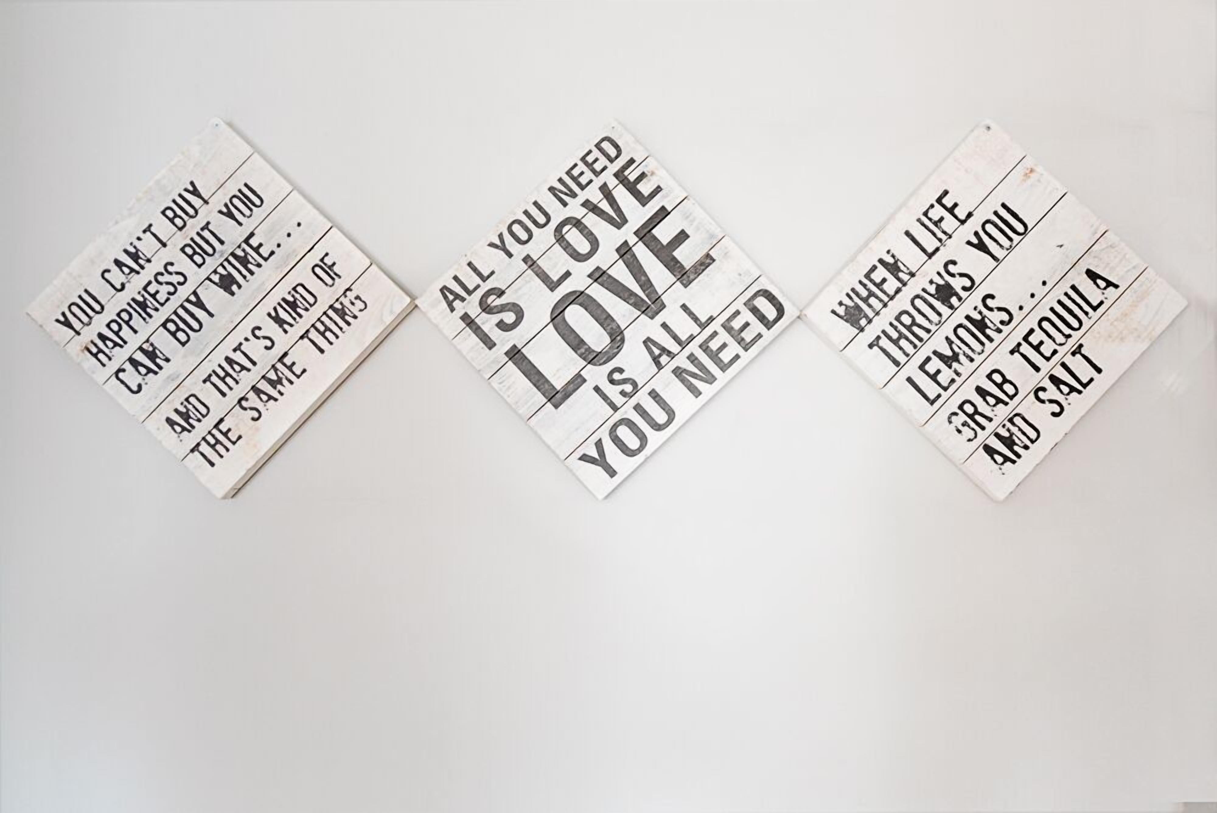 Three signs with motivational quotes.