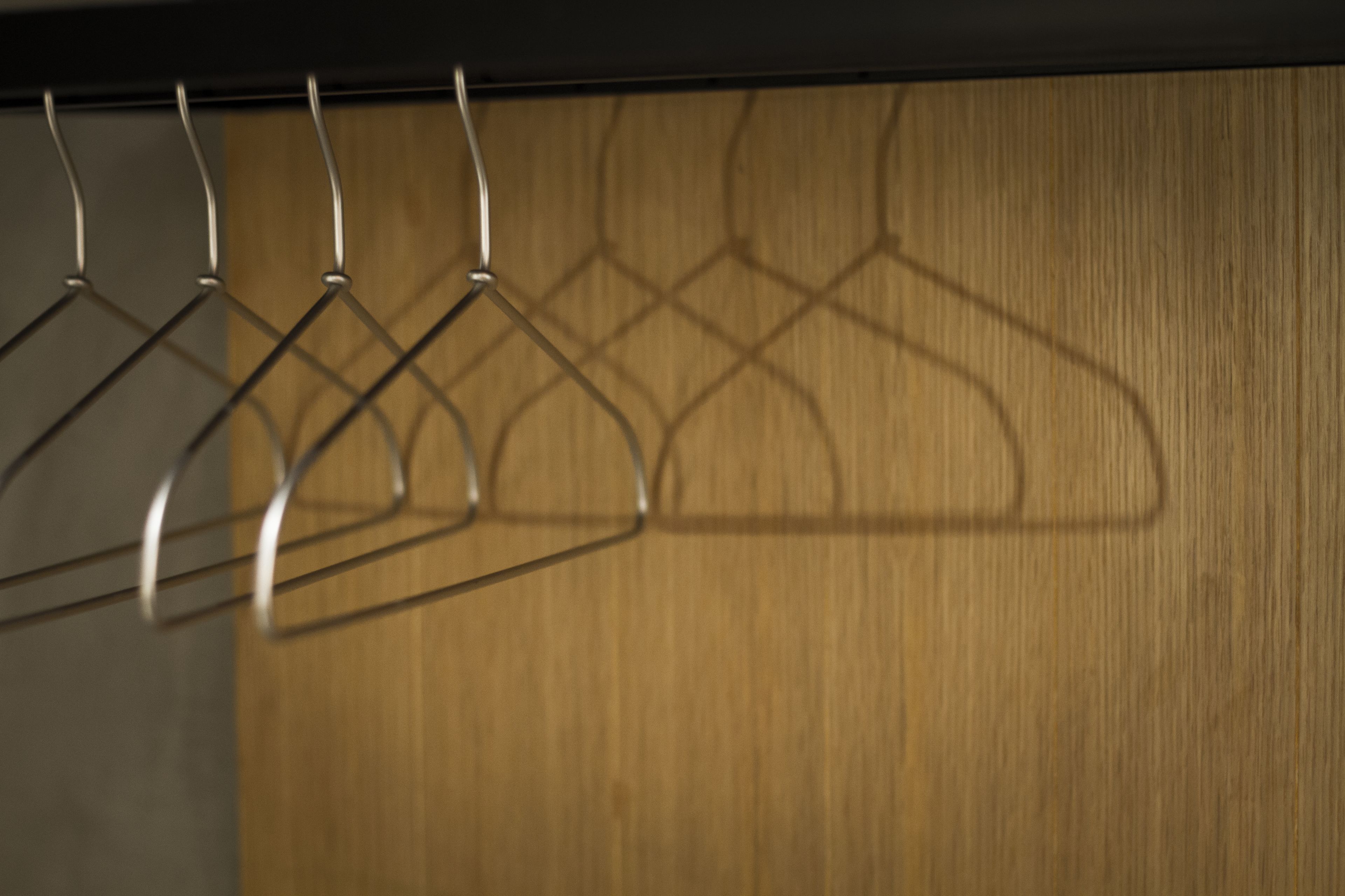 A wooden wall with metal hangers.
