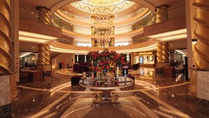 A spacious lobby with a central fountain, multiple seating areas, and a grand chandelier. - Crystal Prestige Pearl Collection - All inclusive (Kemer)