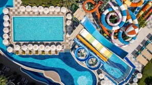 A large pool with a checkered pattern, surrounded by lounge chairs and umbrellas. - Crystal Prestige Pearl Collection (Kemer)