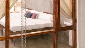 A bedroom with a bed, curtains, and a window. - Niyati - Boutique Stay (Kochi)