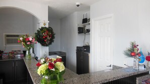 A kitchen with granite countertops, a refrigerator, and a coffee machine. - Budget Inn St. Augustine (St. Augustine)