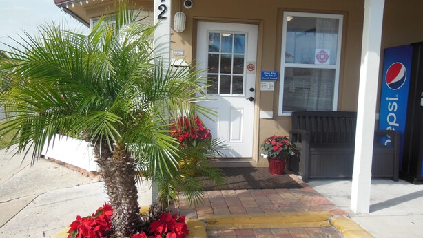 A building with a door, a sign, and a Pepsi sign. - Budget Inn St. Augustine (St. Augustine)