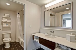 A modern bathroom with a toilet, shower, and sink. - Hampton Inn & Suites Detroit/Troy (Troy)