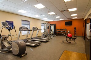 A gym with treadmills, elliptical machines, and a weight bench. - Hampton Inn & Suites Huntsville (Huntsville)