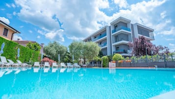 Seasonal outdoor pool, pool umbrellas, pool loungers