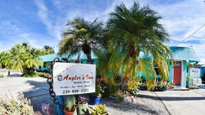 A sign for Angler's Inn in Melita, Florida, with a contact number. - Angler's Inn (Matlacha)