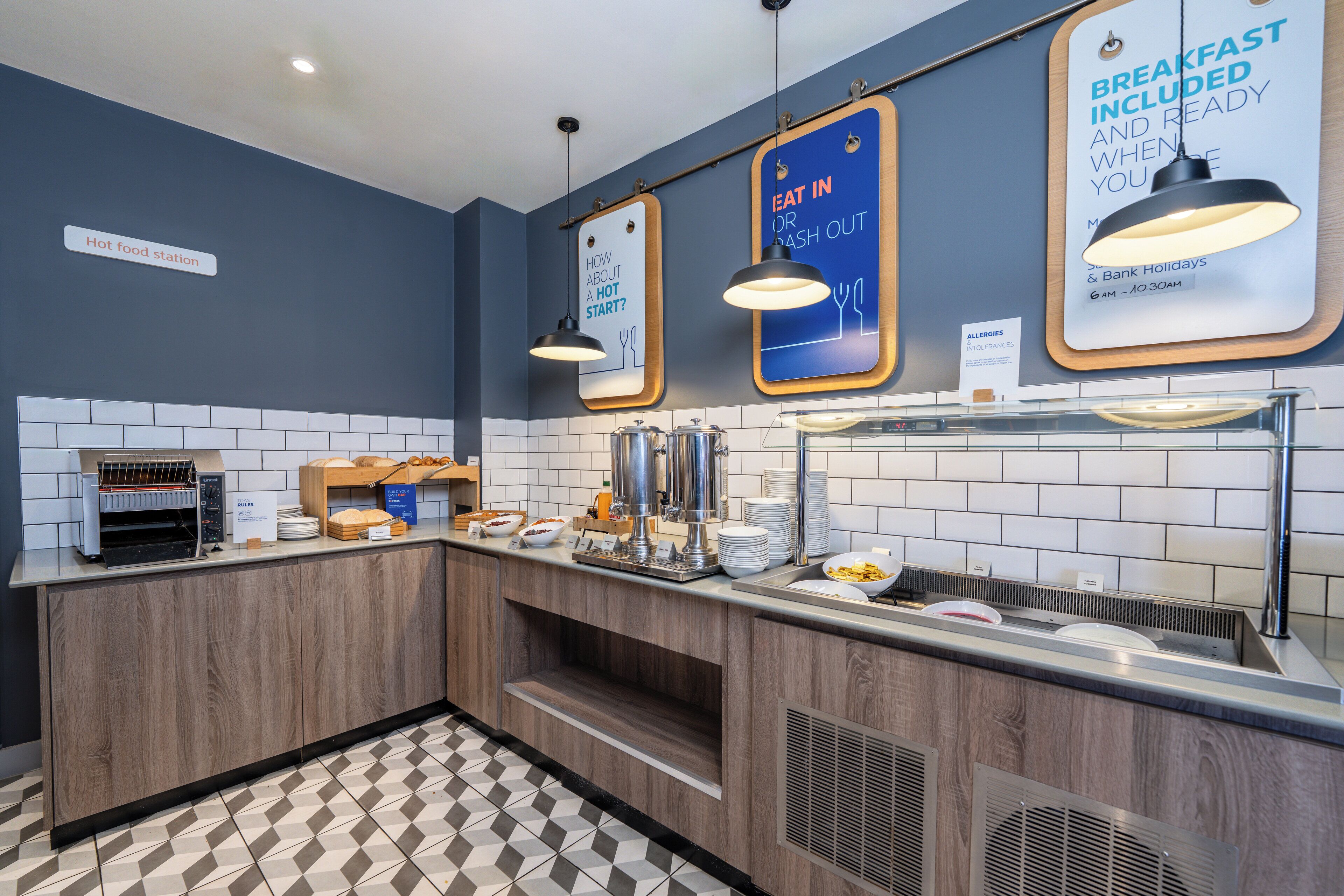 A breakfast station with a sign indicating breakfast is included and ready when you arrive.