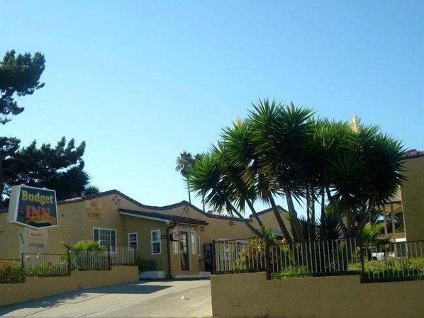 A building with a sign for Budget Inn, featuring a simple facade with a flat roof and a small entrance.