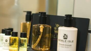 A display of Noble Isle hand care products including hand lotion and shower gel.