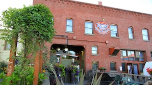 A brick building with a sign for the Olympic Club Hotel & Bar. - McMenamins Olympic Club (Centralia)
