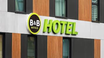 A hotel sign with "B&B HOTELS" and a green "HOTEL" sign.