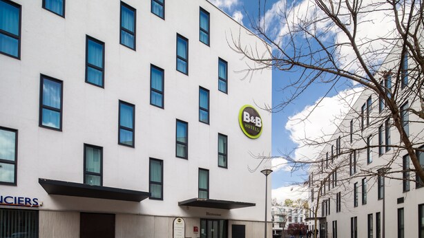 A modern hotel with a white facade and multiple windows. - B&B HOTEL LILLE Tourcoing Centre (Tourcoing)