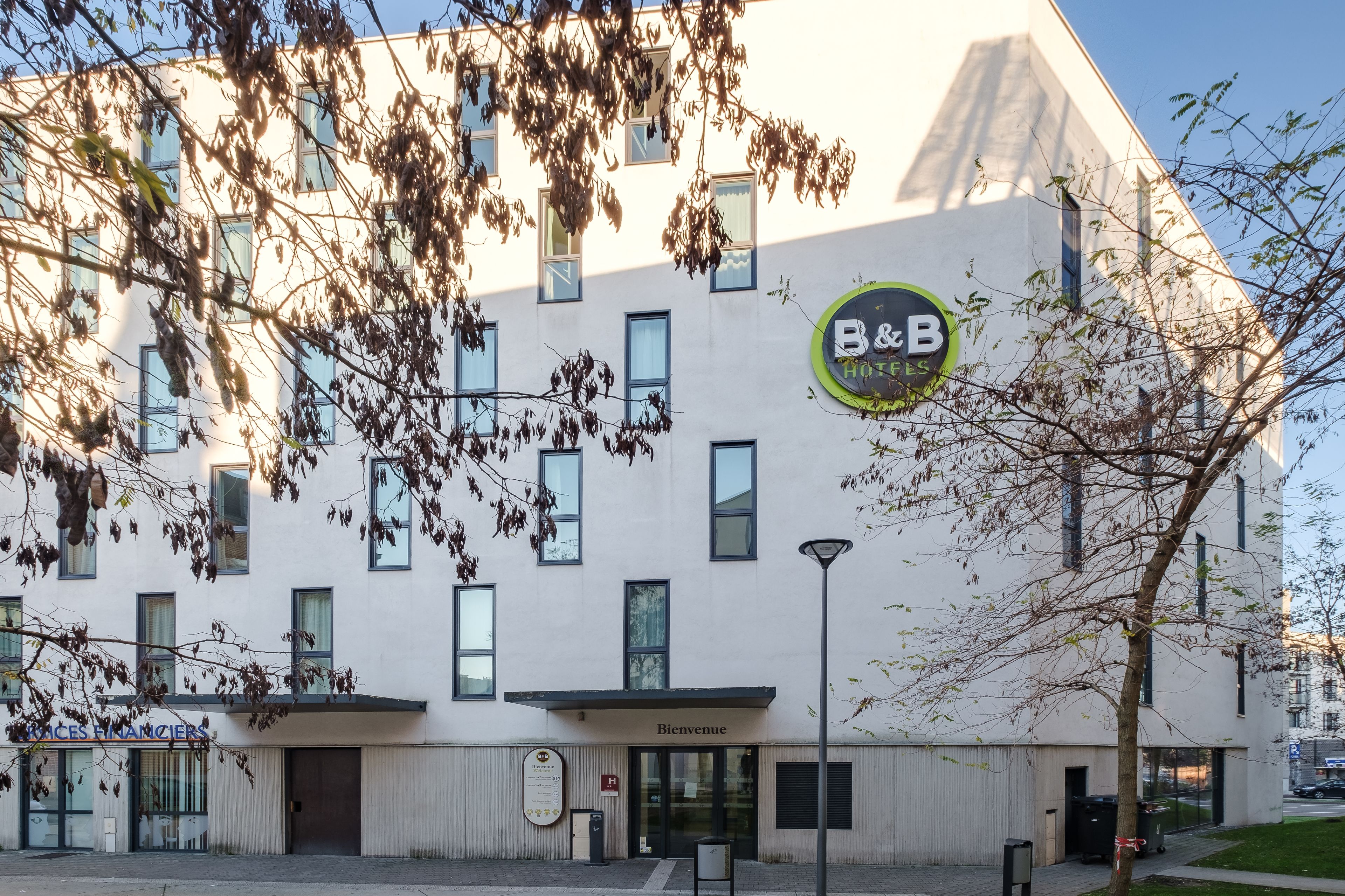 A modern building with a sign for B&B Hotel.