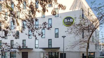 A modern building with a sign for B&B Hotel.