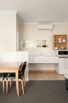 A modern kitchen with a microwave, sink, and cabinet.