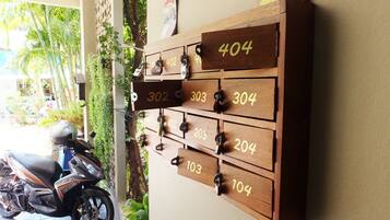 A wall-mounted wooden number board with room numbers 302 to 404.
