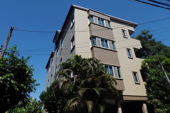 A multi-story building with a flat roof and a symmetrical facade.
