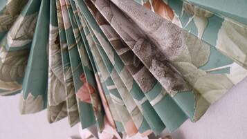 A folded fan with a floral pattern.
