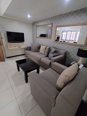 Habitación superior, 1 habitación | Área de sala de estar | Televisión LED de 32 pulgadas con canales por cable y televisión 