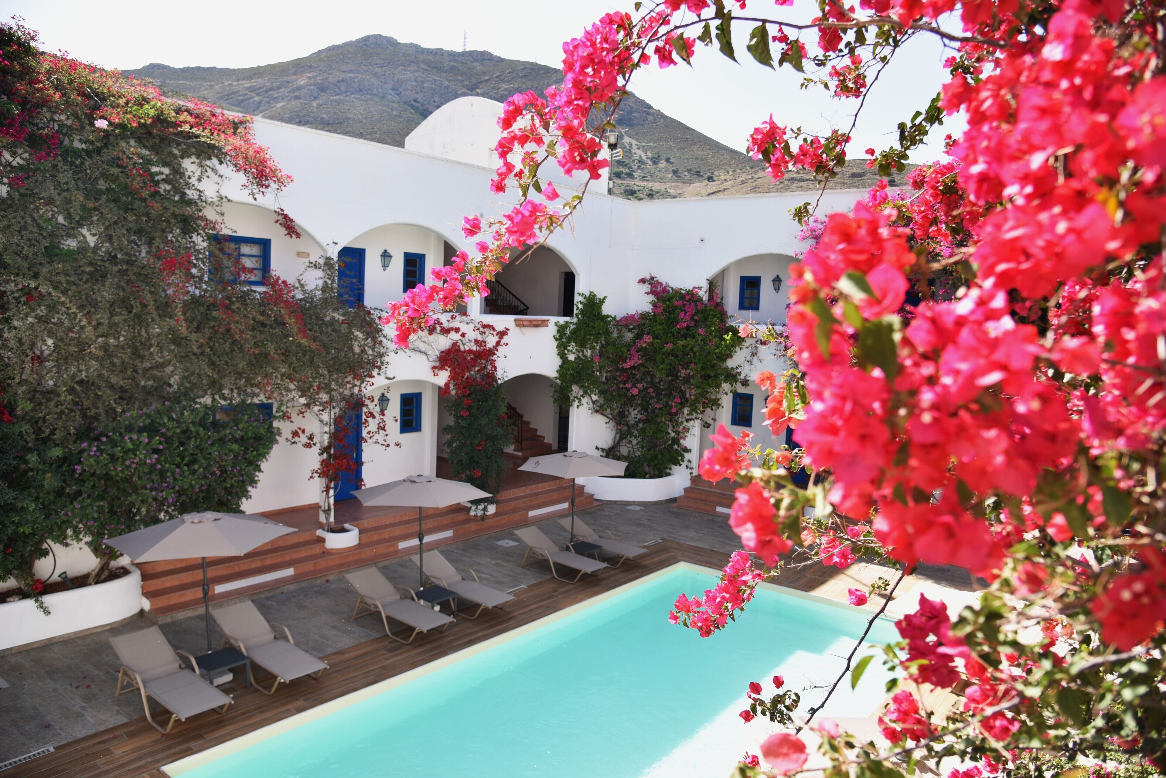 Outdoor pool, a rooftop pool, pool umbrellas, pool loungers