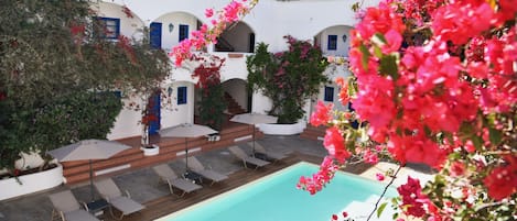 Outdoor pool, a rooftop pool, pool umbrellas, pool loungers