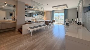 A modern living room with a sofa, dining area, and kitchen. - Kalyon Çeşme (Cesme)