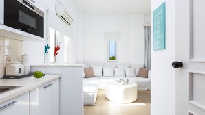 A modern kitchen with a built-in oven, a white countertop, and a green apple on the counter. - Aqua Marina (Rethymno)