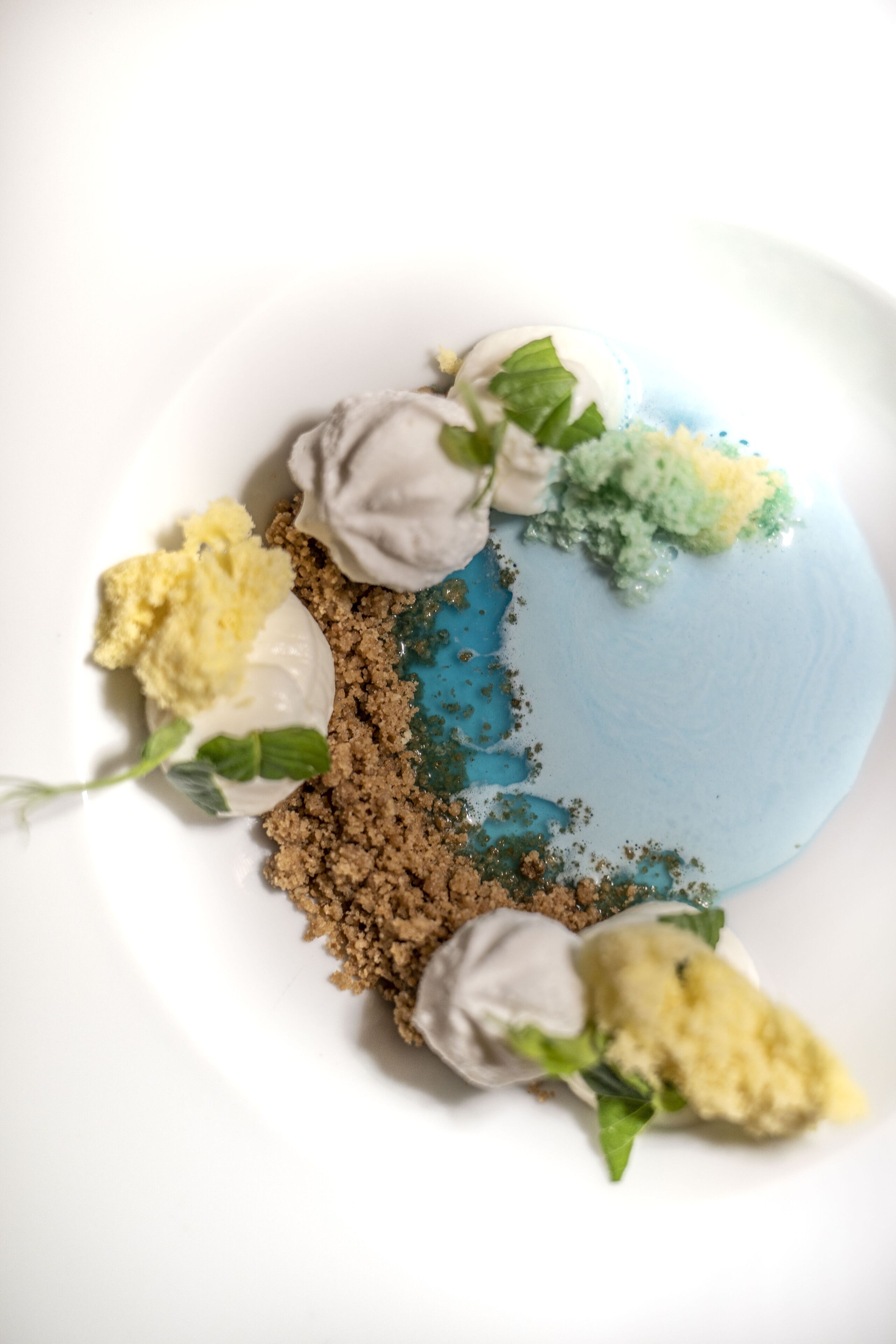 A dessert with various components on a white plate.