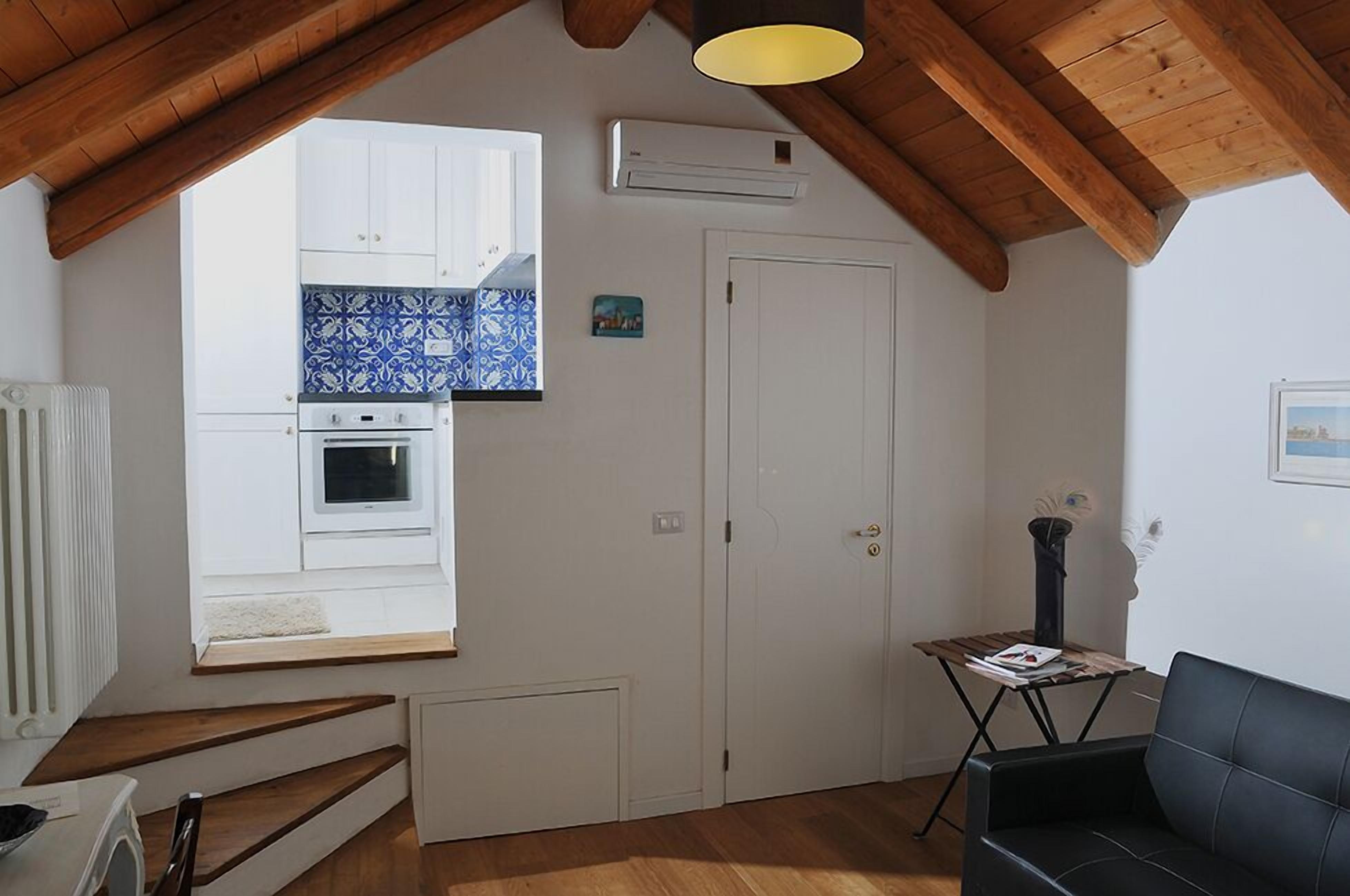 A compact living space with a kitchen, a dining area, and a seating area.