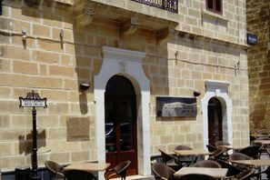 A stone building with outdoor seating and a sign reading "The Fat Rabbit." - Quaint Boutique Hotel Nadur (Nadur)
