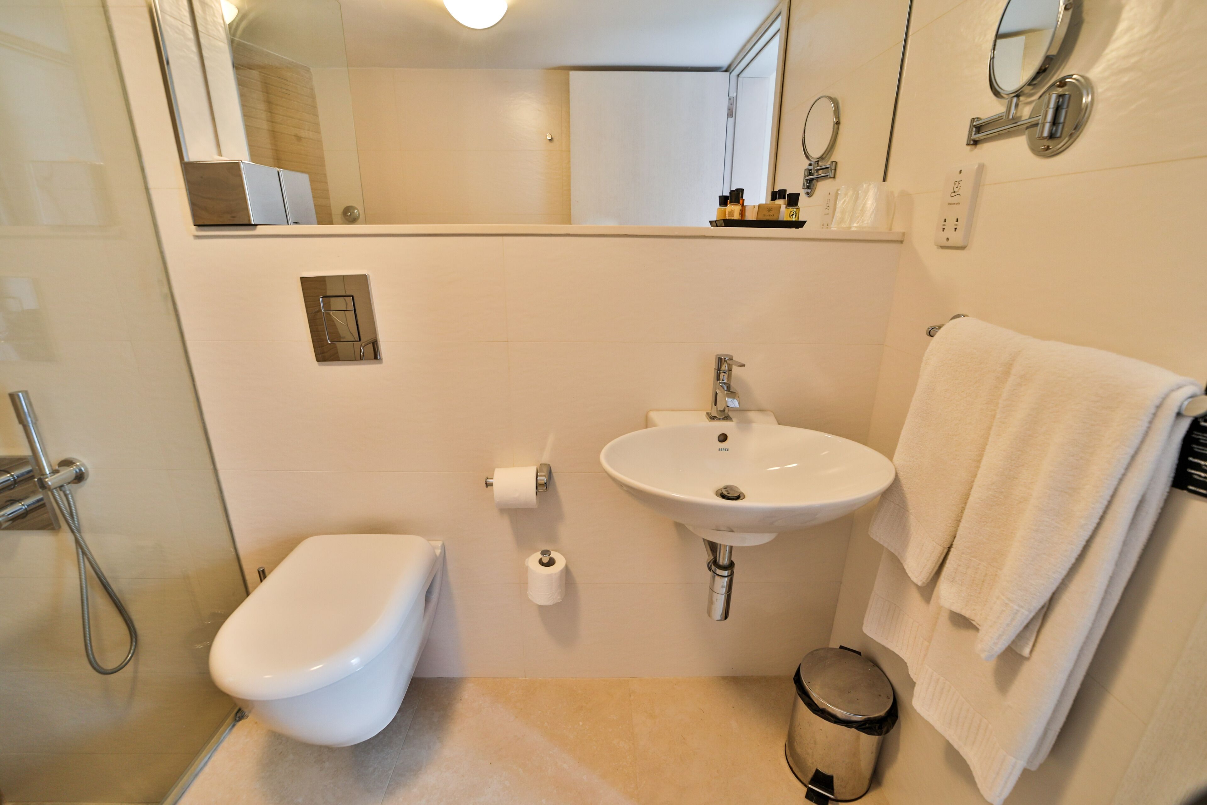 Un baño moderno con inodoro, lavabo y ducha.