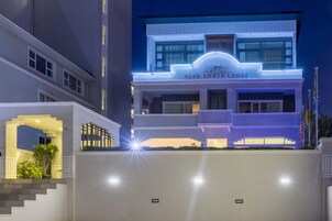 A modern hotel with a prominent sign reading "HEAD SOUTH LODGE."
