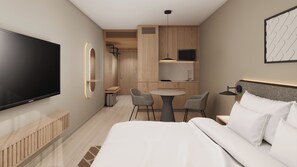 A hotel room with a bed, a TV, a desk with chairs, a kitchen area, and a bathroom.
