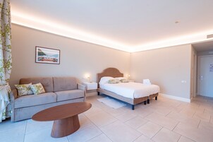 Junior suite, gedeeltelijk uitzicht op meer | Donzen dekbedden, een minibar, een kluis op de kamer, een bureau