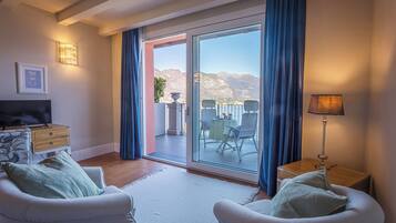 Suite junior, vista al lago | Edredón, minibar, caja de seguridad en la habitación y escritorio