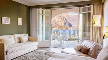 Junior suite, uitzicht op meer | Donzen dekbedden, een minibar, een kluis op de kamer, een bureau