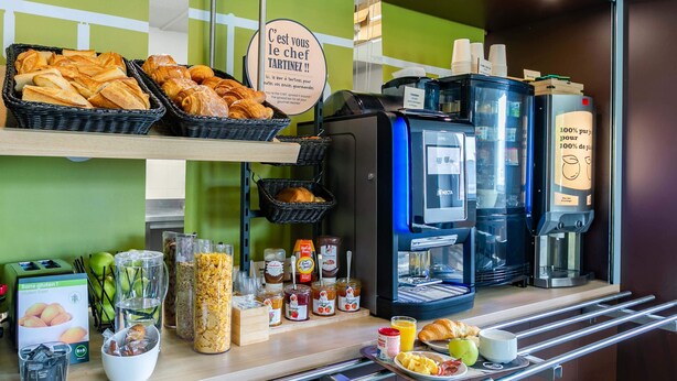 A breakfast buffet with pastries, beverages, and condiments. - B&B HOTEL Strasbourg Nord Artisans (Vendenheim)