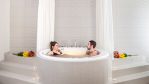 A modern bathroom with a large freestanding bathtub, tiled walls, and a shower curtain. - Estonia Resort Hotel & Spa (Parnu)