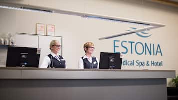 A reception desk at a medical spa and hotel with a sign reading "ESTONIA Medical Spa & Hotel."
