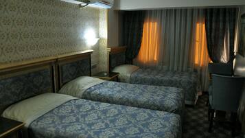 Economy Triple Room | Premium bedding, minibar, in-room safe, desk