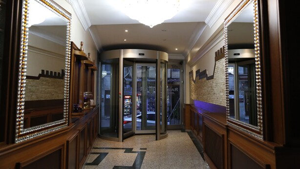 A hotel lobby with a revolving door, large mirrors, and a chandelier. - Grand Hisar Hotel (Istanbul)