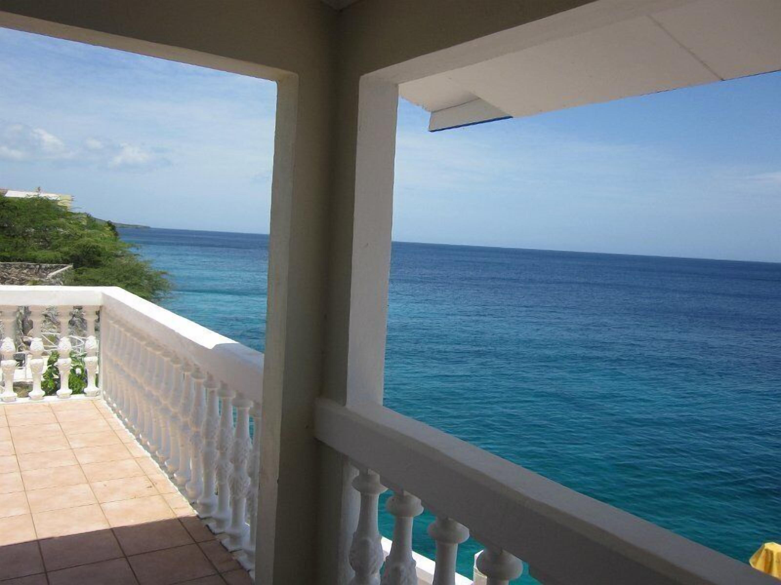 A balcony with a view of the sea.