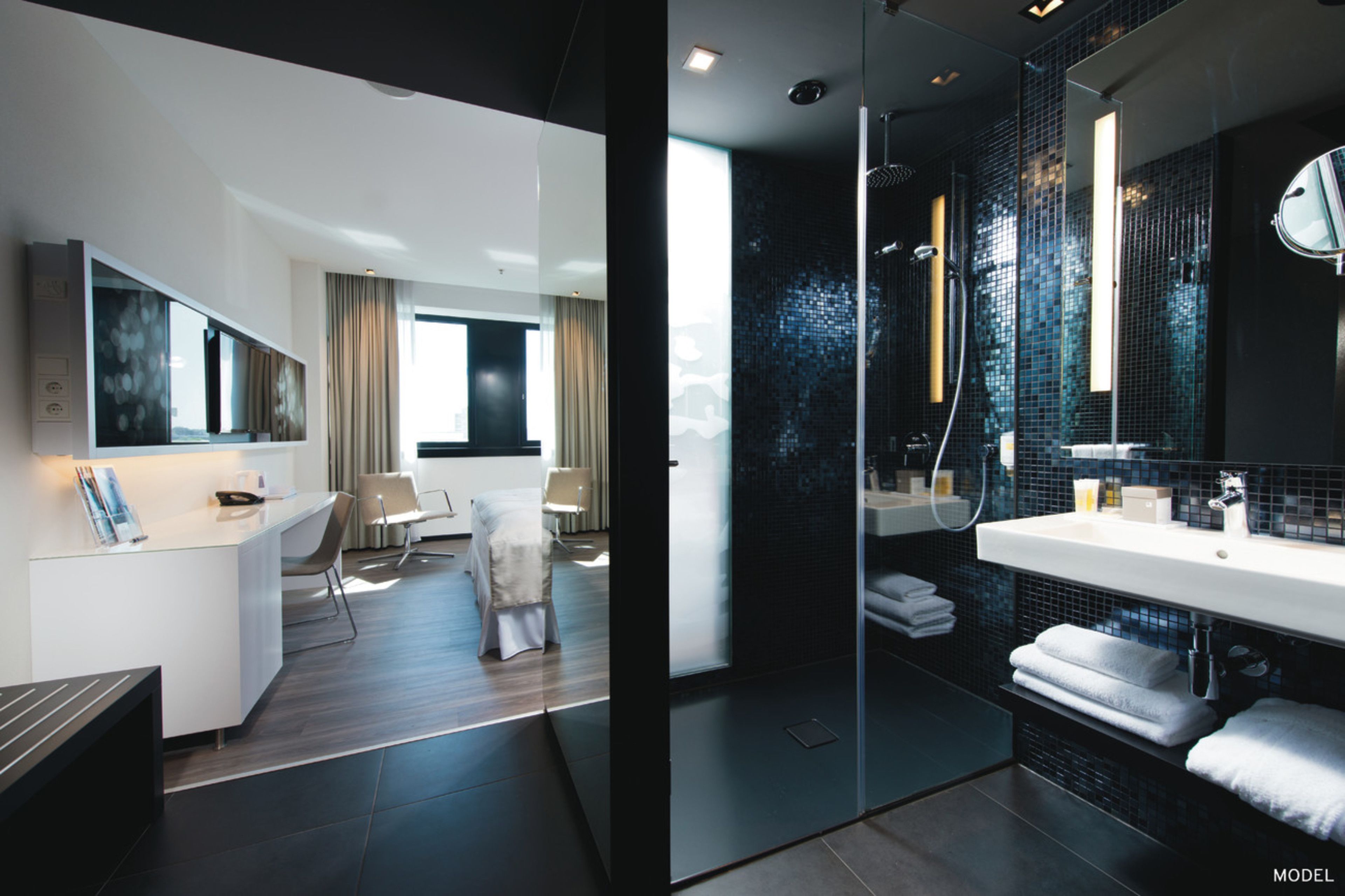 deluxe room | bathroom | shower, eco-friendly toiletries, hair dryer, towels