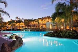 A resort pool with a clear view of the surrounding buildings and palm trees. - The Villas at Bahia del Duque (Adeje)