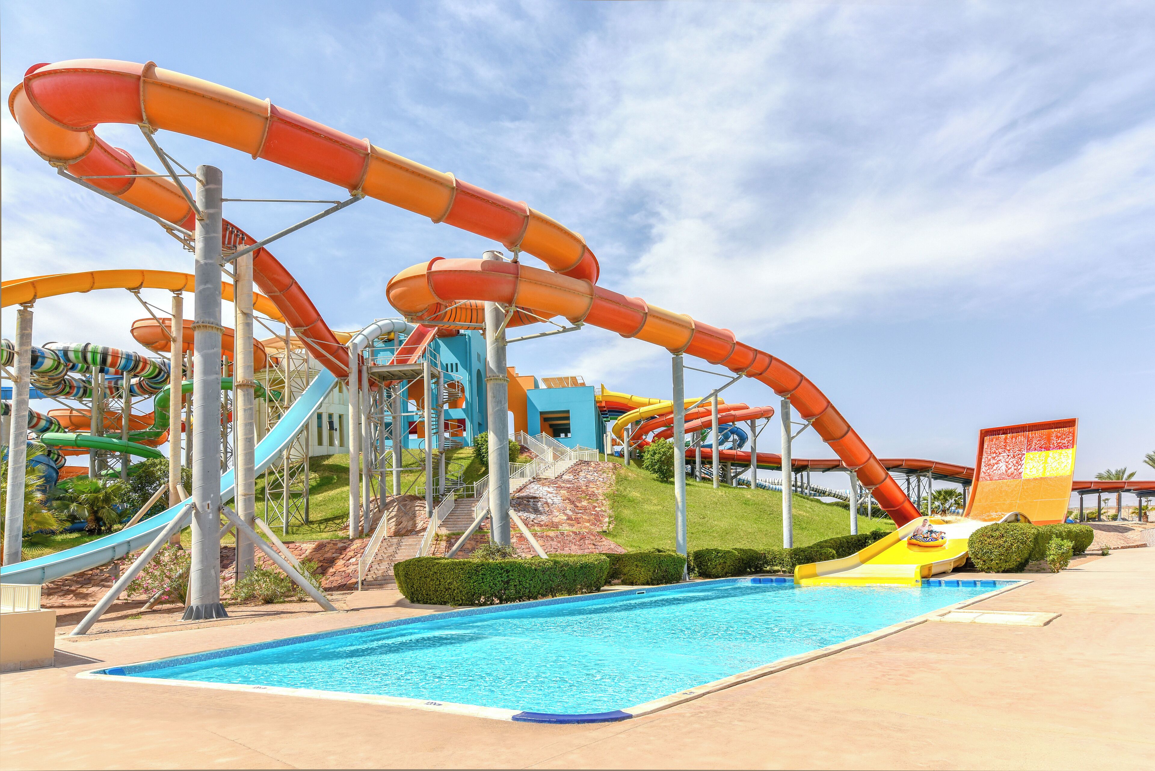 A water park with multiple water slides and a swimming pool.