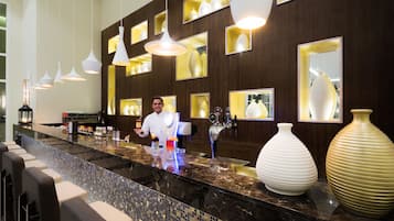 Enjoy a drink at the bar, where bartenders offer a selection of beverages and expertly mix cocktails.