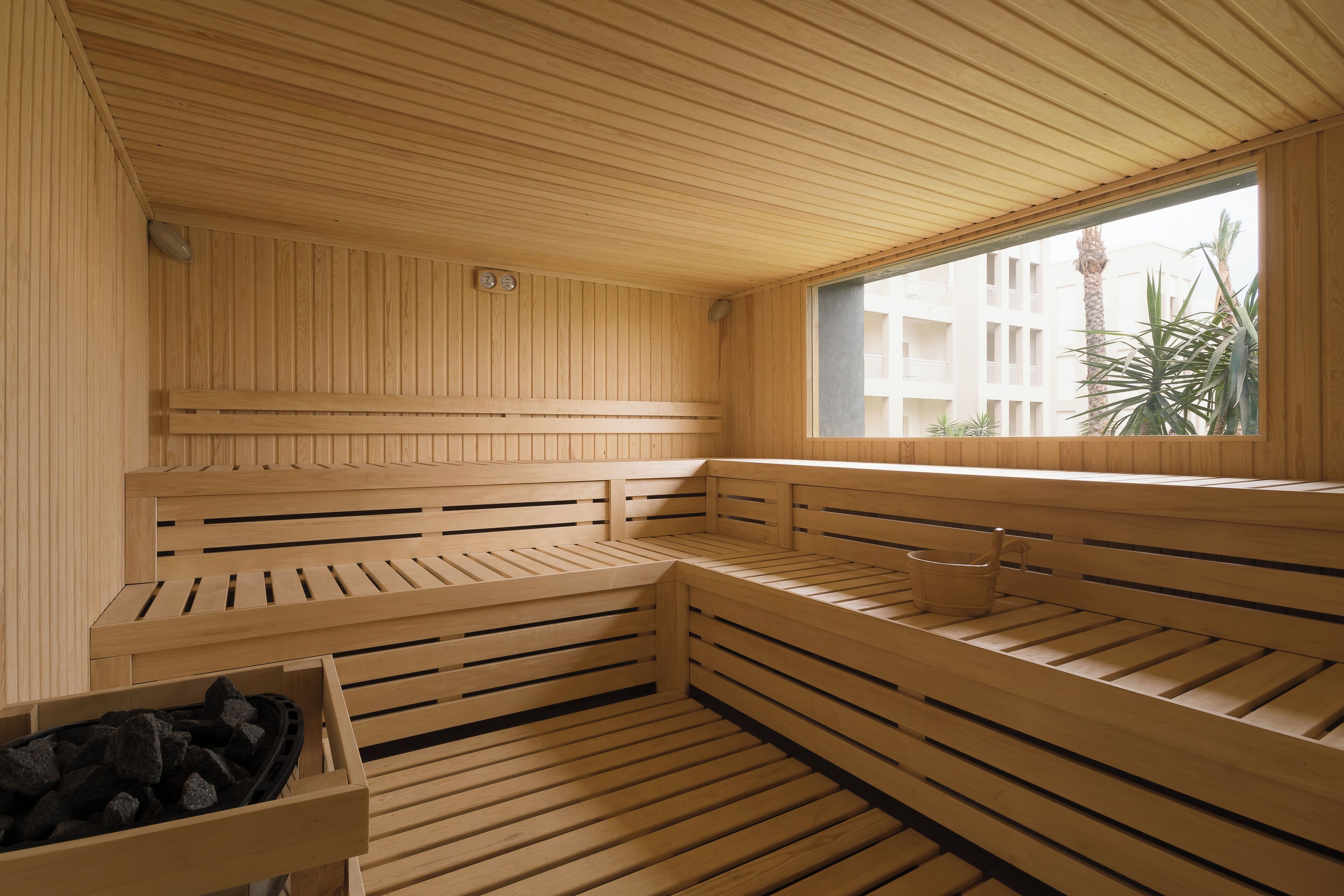 A sauna with wooden benches and a window.