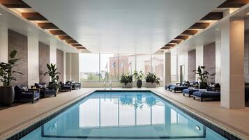 Una piscina techada, sillones reclinables de piscina